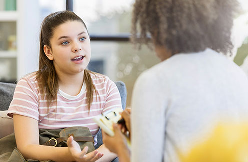 a young girl talking with a counsellor