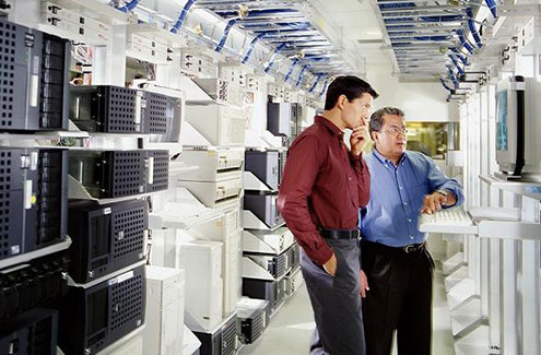 Two professionals on a computer screen in the server room