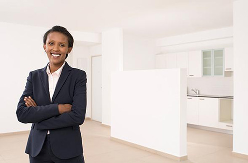 woman in a suit standing in a condominium