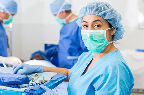 Three professionals in an operating room